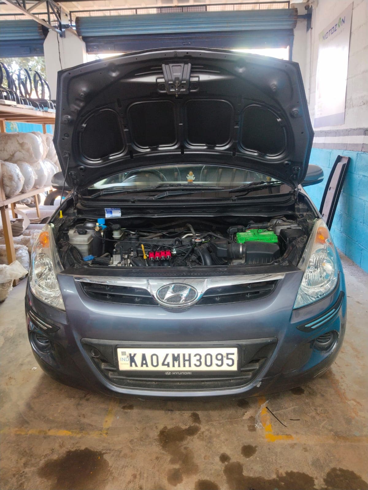 Hatchback in the workshop with its bonnet open and a sequential CNG kit fitted
